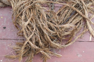  Texture of old rope on the background of wooden boards floor