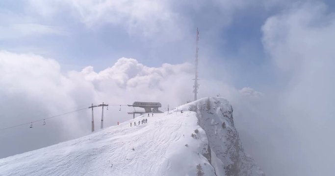 Villars top lift close up out of clouds - Aerial 4K