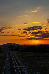 Beautiful summer sunset over empty sunlit railway tracks near Krum, Southern Bulgaria, elevated view from a bridge