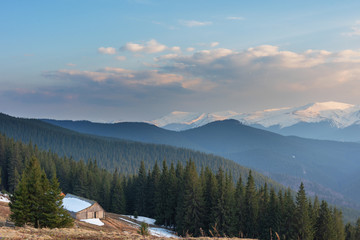 Rest on a mountainous valley with a view of the snow-capped peaks of Ukrainian carpathians in the spring period.