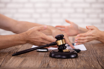 Couple Arguing Each Other And Mallet With Golden Rings