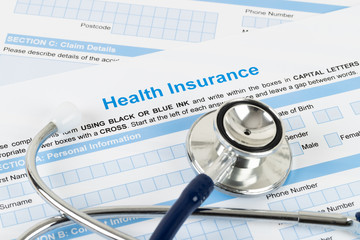 Health insurance application form with stethoscope and calculator