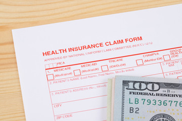 Health insurance claim form on wooden desk