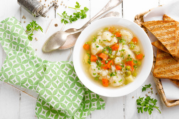 Vegetable soup with cauliflower, carrot, green peas, onion and potato