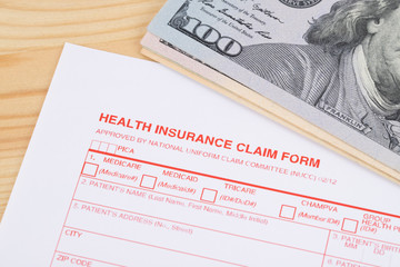 Health insurance claim form on wooden desk
