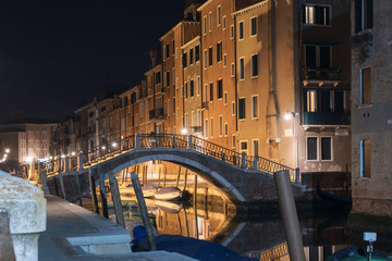 Fototapeta na wymiar Illuminated bridge over the canal