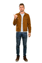 Fototapeta premium Blonde handsome man unhappy and pointing to the side