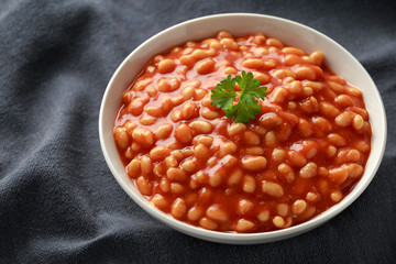 Baked beans in tomato sauce in white bowl