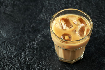 iced caramel coffee in a glass with cold milk. Summer drink
