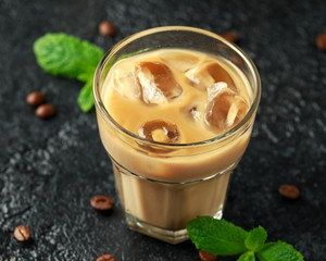 iced caramel coffee in a glass with cold milk. Summer drink