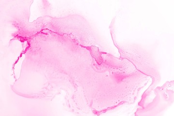 Pink alcohol ink texture with abstract washes and paint stains on the white paper background.	