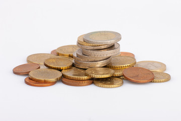 Euro coins stacked on each other in different positions. Selective focus