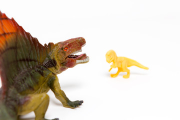 Two toy dinosaurs on an isolated white background
