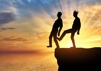 Selfish man with a crown is pushing the foot of his business partner into the abyss