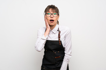 Young woman with apron with surprise and shocked facial expression