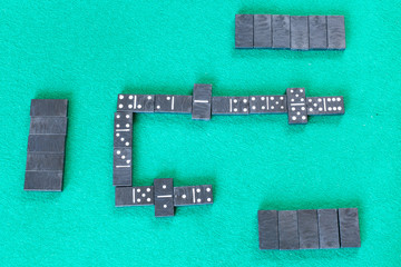 gameplay of dominoes board game with black tiles