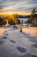 Fototapeta na wymiar Sunrise with Footsteps on Snowy Hike in the Colorado Rocky Mountains