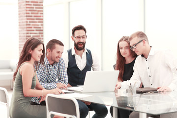 smiling business team looking at laptop screen.