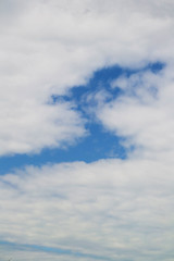 Obraz premium Beautiful clouds - feathers against the blue sky, consecrated by the sun, background for design.