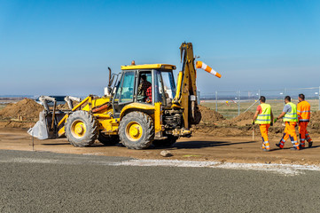 Construction site of road, building or airport with construction machinery (truck, bulldozer,...