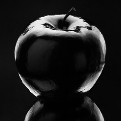 Atmospheric monochrome Art black apple on a black background, black on black Concept Mystical,...