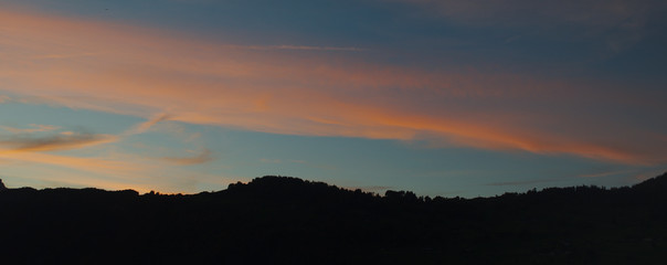 Mountain silhouette with cirrus clouds just after the blue hour