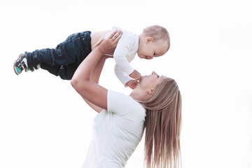mother plays with her son while walking in the Park