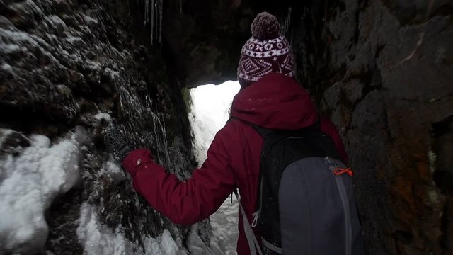 Woman backpacker in a winter hike snow forest trail national par Young girl enjoy snow falling . Happy winter holidays active lifestyle concept.