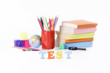 Fototapeta premium word test on the background of school supplies .photo with copy space
