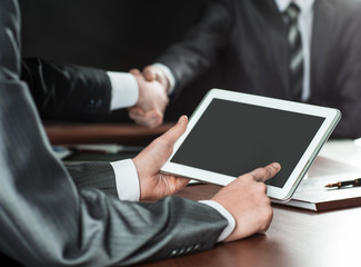 businessman uses a digital tablet at a briefing in the office