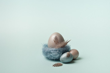 Easter, silver, blue eggs on a blue  background