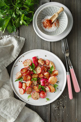 Beautiful roasted radishes served with parsley and sesame seeds in a plate on wooden rustic background.
