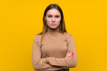 Fototapeta premium Young woman over colorful background keeping arms crossed