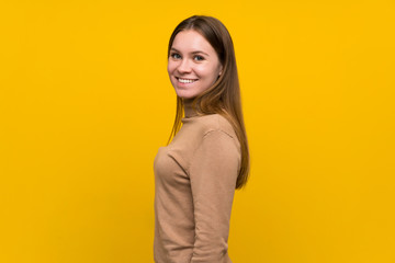 Young woman over colorful background laughing