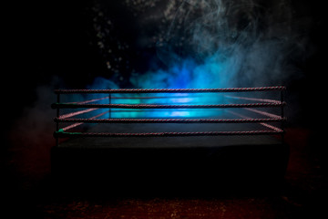 Empty boxing ring with red ropes for match in the stadium arena. Creative artwork decoration