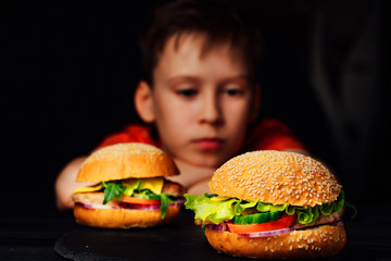Boy on temptation with burger