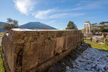 Ruins of Athena pronaia temple in Delphi with snow
