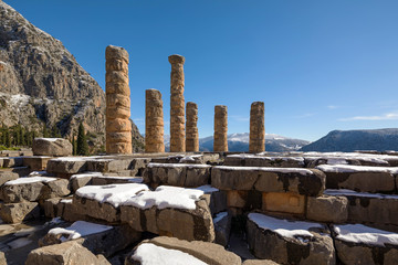 The Apollo temple ruins with snow in Delphi, Greece