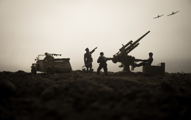 An anti-aircraft cannon and Military silhouettes fighting scene on war fog sky background. Allied...