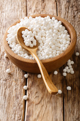 Tapioca balls a product of tapioca, a starch extracted from the cassava root closeup in a bowl. vertical
