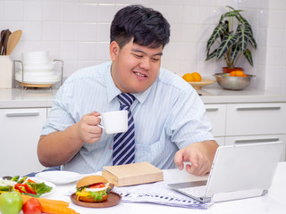 busy asia fat man drinking unhealthy coffee on morning