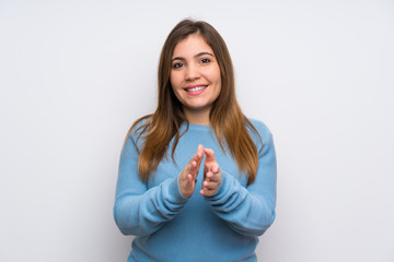 Fototapeta premium Young girl with blue sweater applauding