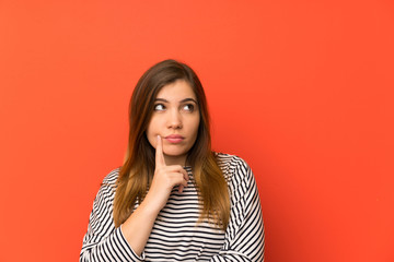 Fototapeta premium Young girl with striped shirt thinking an idea