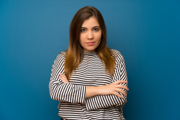 Young girl with striped shirt keeping arms crossed