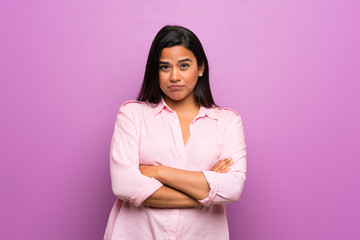 Fototapeta premium Young Colombian girl over purple wall feeling upset