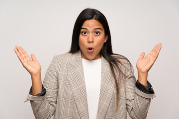 Young Colombian girl over white wall with surprise facial expression