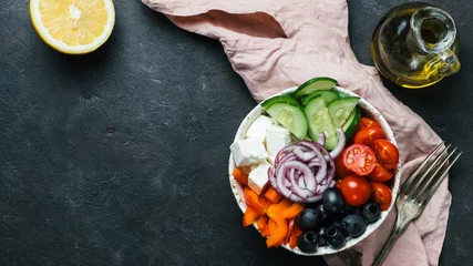 Fotobehang Greek Salad Bowl on dark black background, copy space. Above view of Bowl Greek Salad. Trendy food. Idea, recept and concept of modern healthy food. Banner © fascinadora