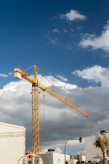 construction crane against clouds and blue sky