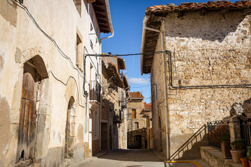 Fototapeta na wymiar street with typical houses in Puertomingalvo village, province of Teruel, Aragon, Spain