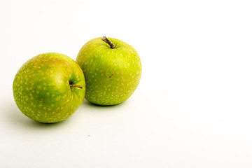Two green ripe apple close up on a white background